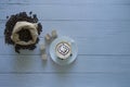 Latte art coffee in a coffee cup and coffee beans isolated with sack bag and coffee wooden dice on top left corner Royalty Free Stock Photo