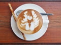 Latte art coffee on the wooden desk. Royalty Free Stock Photo