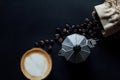 Latte art ,Croissant and moka pot with Roasted coffee on black background in the morning and instagram style filter photo vintage