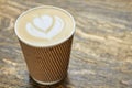 Latte art in paper cup. Royalty Free Stock Photo