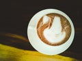 Latte art, swan pattern on hot coffee in white glass Royalty Free Stock Photo