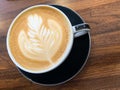 Latte art in mug on wooden table Royalty Free Stock Photo