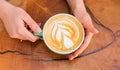 Latte art on wooden table. Cup of coffee with heart shape. good morning coffee. Cappuccino style. barista serve coffee Royalty Free Stock Photo