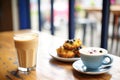 latte with blueberry muffin on a caf table