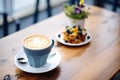 latte with blueberry muffin on a caf table