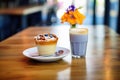 latte with blueberry muffin on a caf table