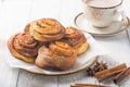 Latte or cacao and Cinnamon Bun for breakfast or break on white background. Cup of coffee and homemade buns Royalty Free Stock Photo