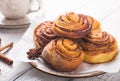 Latte or cacao and Cinnamon Bun for breakfast or break on white background. Cup of coffee and homemade buns Royalty Free Stock Photo