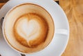 Close up of the latte art in heart shape at the bottom of a cup of hot coffee.