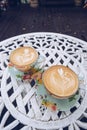 A set of vintage twin hot coffee latte on the table.