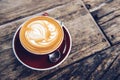 Close up of hot latte coffee serving on the wooden table.