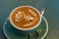 Latte coffee with latte art in a coffee cup with tea spoon Royalty Free Stock Photo