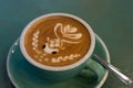 Latte coffee with latte art in a coffee cup with tea spoon Royalty Free Stock Photo