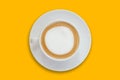 latte coffee in a ceramic coffee cup isolated on bright yellow background top view Royalty Free Stock Photo