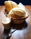Latte glass with a basket breads. Brazilian breakfast with a traditional \