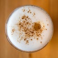 Latte macchiato with cinnamon on the wood table