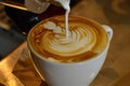 latte in midpour with milk swirling into the espresso Royalty Free Stock Photo