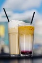 Latte with whipped cream and milky berry cocktail with blackberries and caramel Royalty Free Stock Photo