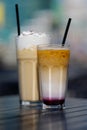 Latte with whipped cream and milky berry cocktail with blackberries and caramel Royalty Free Stock Photo