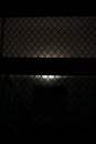 Lattice in dark. Steel grille at back entrance. Interior details Royalty Free Stock Photo