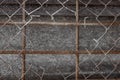 lattice of metal rods and a hole in the mesh netting Royalty Free Stock Photo