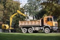 Latvia. Excavator loads trash