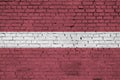 Latvia flag is painted onto an old brick wall Royalty Free Stock Photo