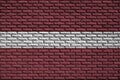 Latvia flag is painted onto an old brick wall Royalty Free Stock Photo