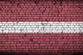 Latvia flag is painted onto an old brick wall Royalty Free Stock Photo