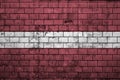 Latvia flag is painted onto an old brick wall Royalty Free Stock Photo