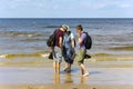 A family walks along the coast of the Baltic Sea in the Majori resort town, Jurmala.