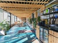 Sunny veranda of a cafe with a wooden ceiling and large windows in Jurmala