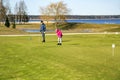 Family playing golf on the banks of the beautiful Kisezers lake Royalty Free Stock Photo