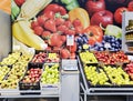 Fresh fruit section for sale at a vegetable with control weights in the center of a supermarket.