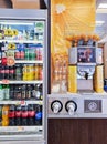 Fresh orange fruits in orange juice machine with plastic bottles for takeout