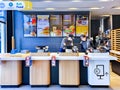 McDonalds counter with menu of different fast food snacks and cash desk in Riga Royalty Free Stock Photo