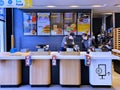 McDonalds counter with menu of different fast food snacks and cash desk in Riga Royalty Free Stock Photo