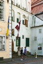 Tourists study history of three buildings historic houses in Old Riga Royalty Free Stock Photo