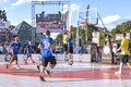 Urban basketball players playing basketball on sports court in Riga