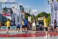 Urban basketball players playing basketball on sports court in Riga