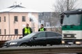 Latvia, Riga - December 1.2017: Municipal police of Riga, Latvia at the place of accident by the car. Smoking electronic cigartes