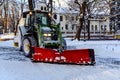 Snowplow truck removing snow in Riga city park