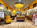 Modern interior in yellow colors of L`Occitane En Provence skincare boutique in shopping mall, Riga Royalty Free Stock Photo