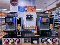 Two coffee machine with different pastries and fast food snacks.