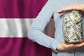 Latvian business, banking and currency exchange concept. US dollars and flag of Latvia