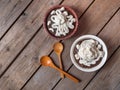 Latvian dessert bread soup in two deep ceramic bowls with whipped cream on a wooden table