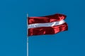 Latvian flag blowing in the breeze.