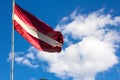 Latvian flag blowing in the breeze. Royalty Free Stock Photo