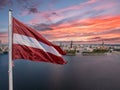 Latvian flag with the Dome Cathedral and an old town in the background Royalty Free Stock Photo