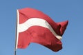 Latvian flag flying on flagpole